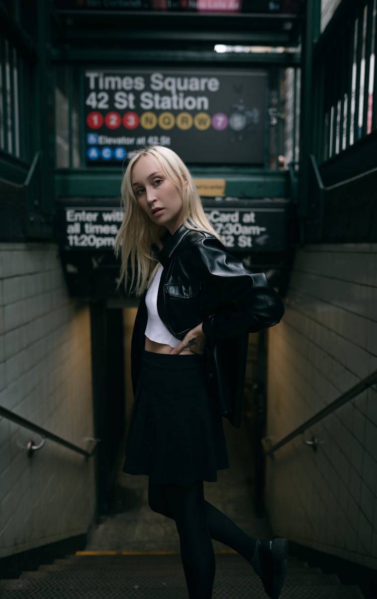 Young Blonde Woman Standing On The Stairs On A Subway Station 