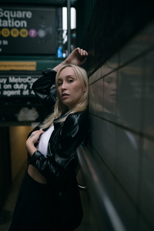 Young Blonde Woman Standing on the Stairs on a Subway Station 