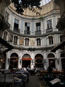 Chic historical arcade featuring dining tables in Beyoğlu, Istanbul, Turkey.