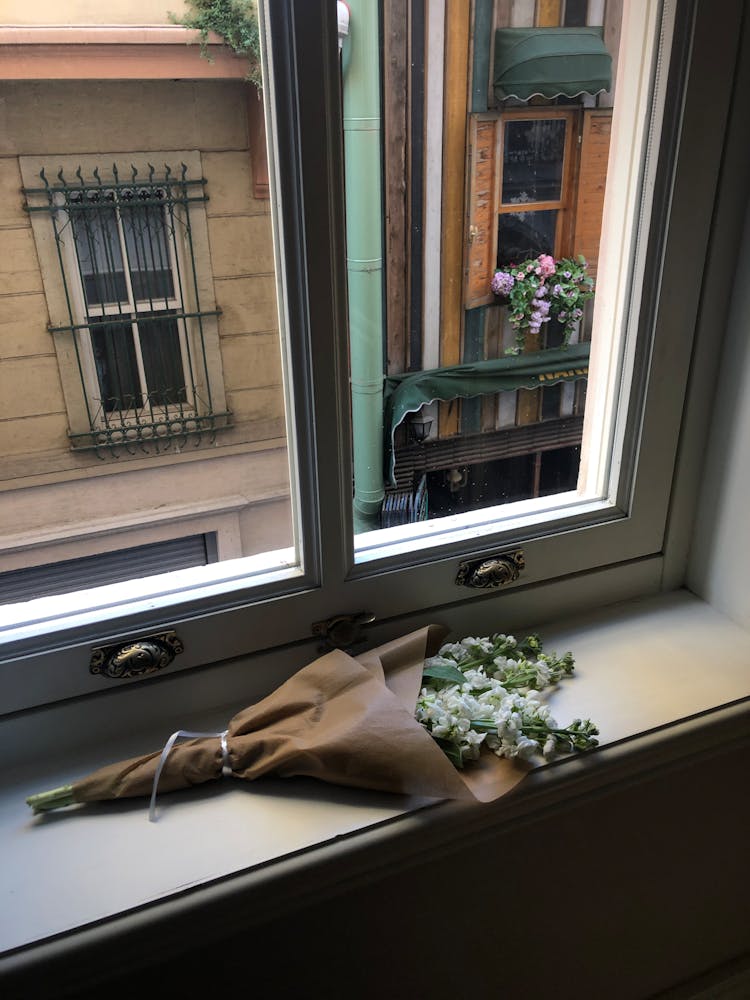 White Flower Bouquet On A Window Pane 