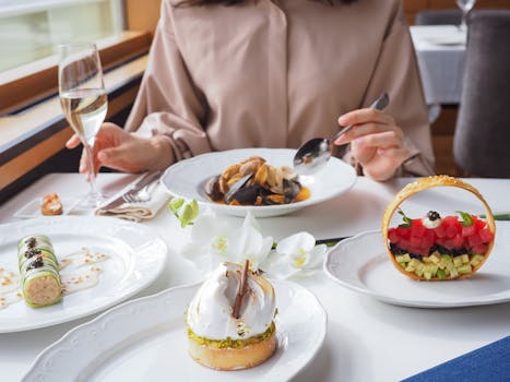 An elegant dining setting featuring gourmet dishes and fine dining ambiance, highlighting artful food presentation.