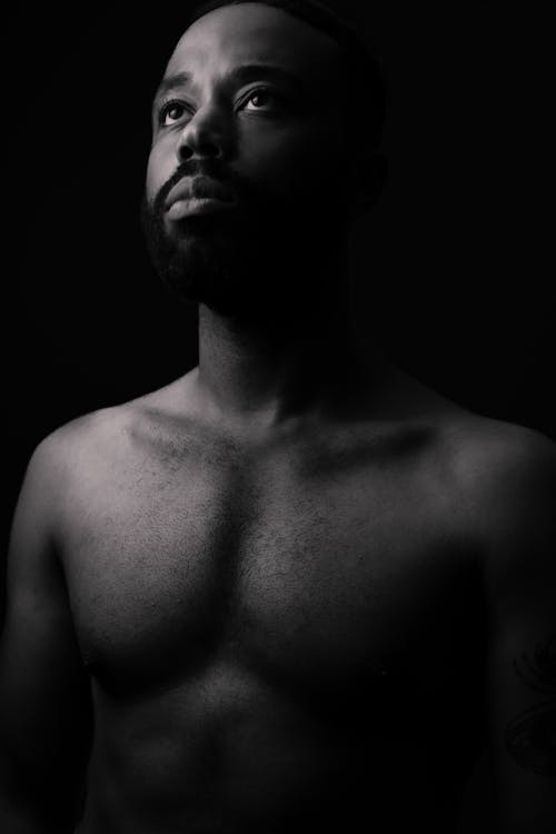 Grayscale Photo of a Shirtless Man 