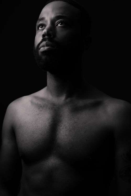 Free Intense black and white portrait of a shirtless man with a contemplative expression. Stock Photo