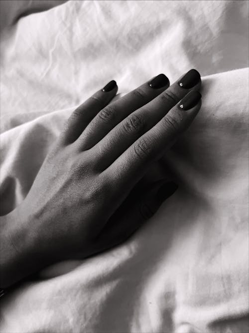 Grayscale Photo of a Hand With Nail Polish 