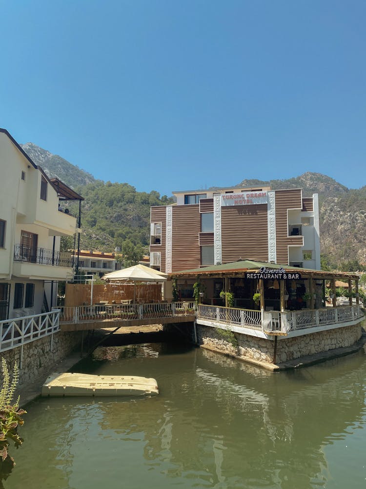 White And Brown Concrete Building Beside River