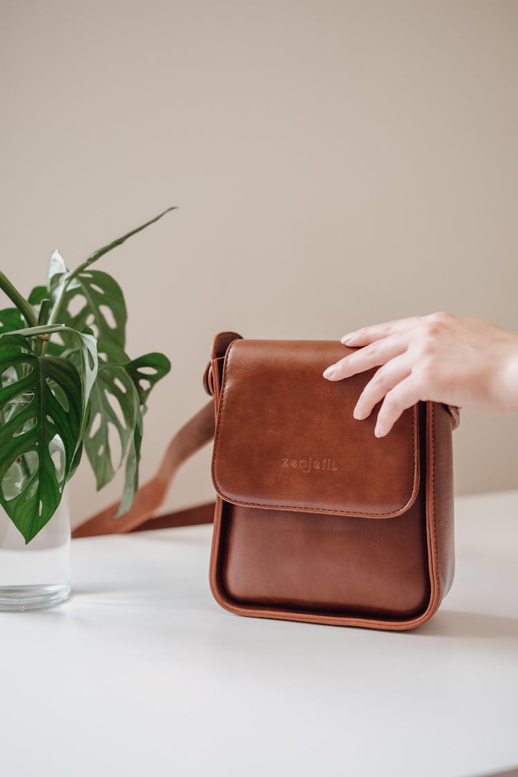 Close Up Of Hand Reaching For Bag