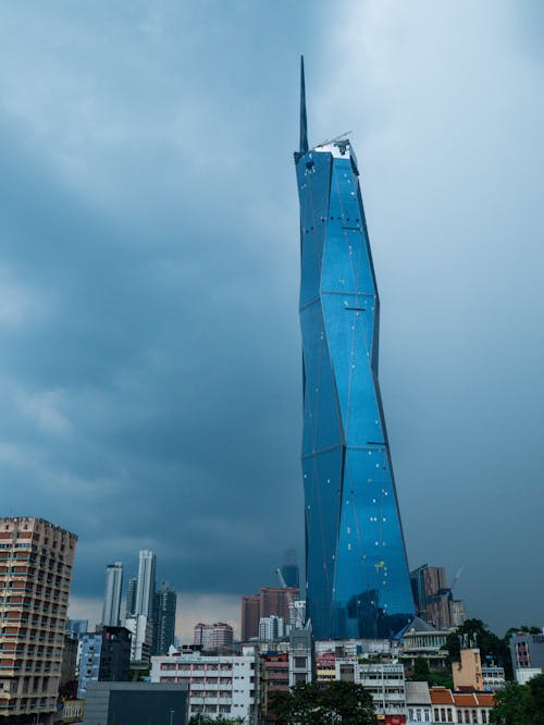 Blue Glass Building under Gloomy Sky 