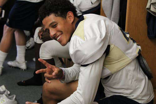 Man in White Jersey Doing Peace Hand Sign