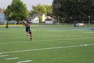 American Football Player Holding Ball