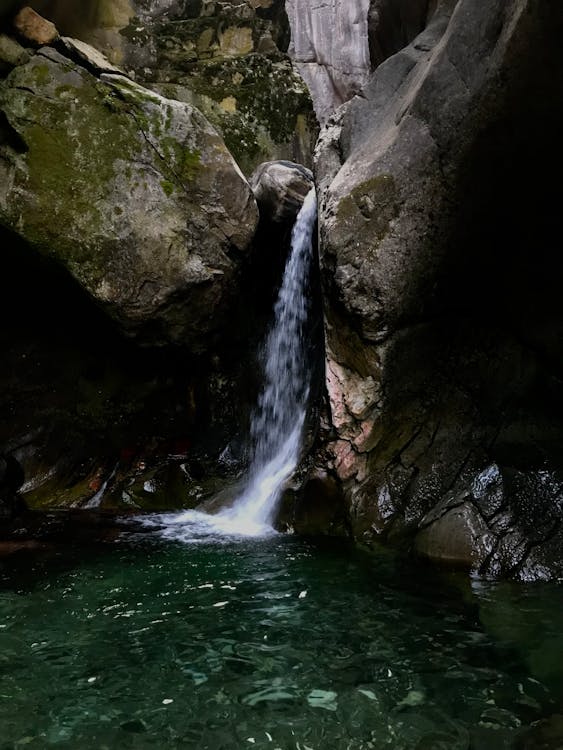 Water Falls in the Middle of Rock Formations 