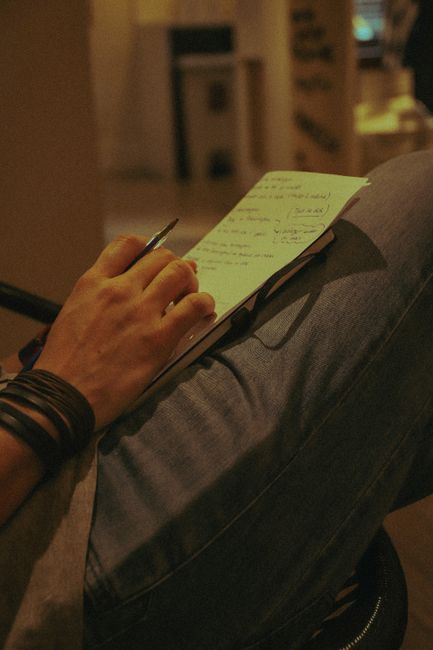Hands writing a personal note on paper