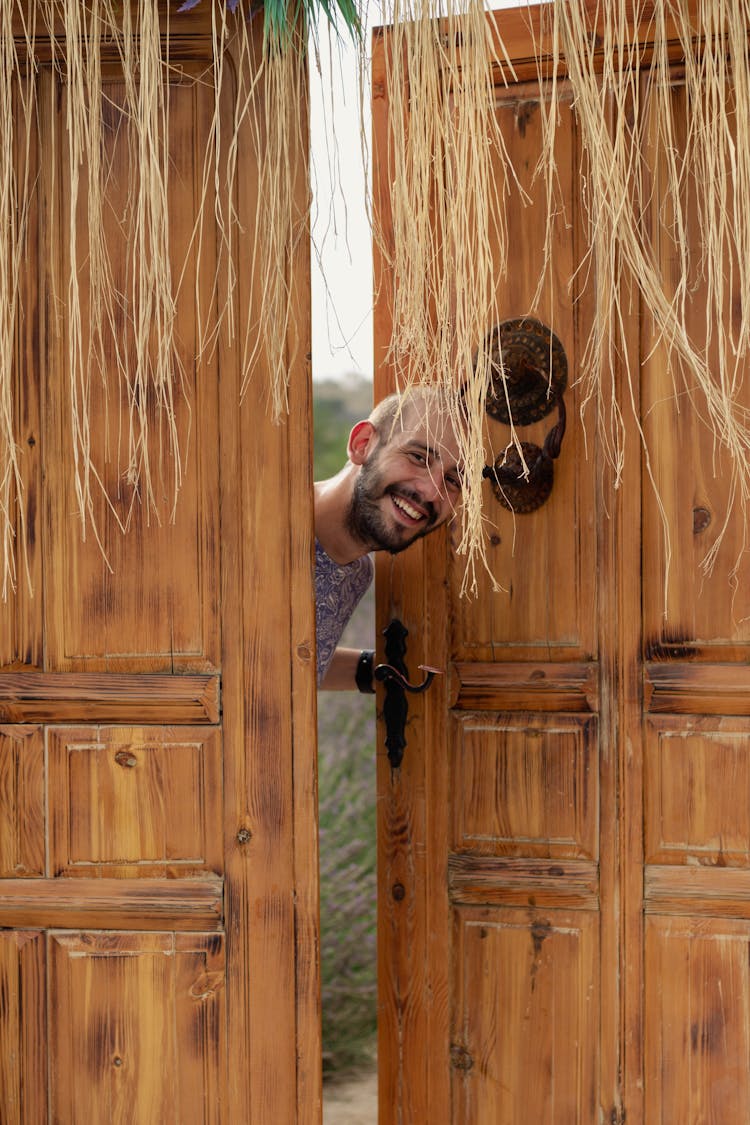 Man Peeking On A Wooden Door 