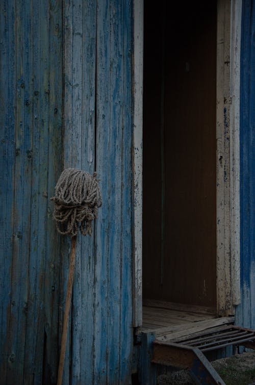 Mop Leaning against a Wooden Hut