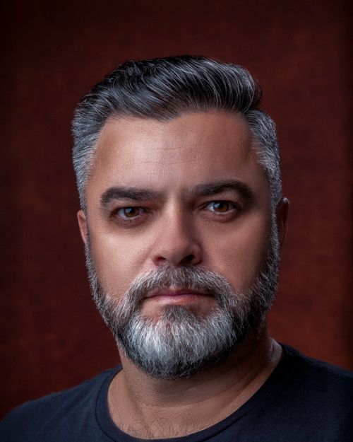 Free Studio portrait of a mature man with a beard and gray hair, captured in a detailed close-up. Stock Photo