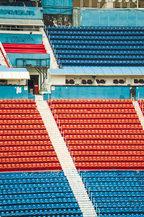 Free A vibrant pattern of blue and red stadium seats with a geometric stairway design. Stock Photo