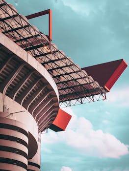 A low-angle view of the iconic San Siro Stadium in Milan, Italy, showcasing its distinctive architecture.