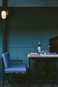 Elegant dining table setting with wine bottle and soft lighting in Istanbul, Turkey.