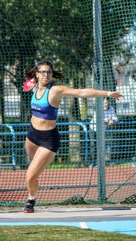 Female athlete practicing discus throw outdoors in Mar del Plata, Argentina.