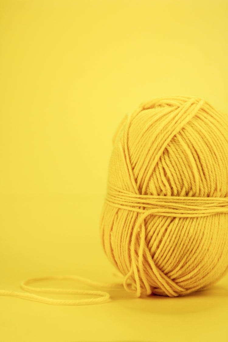 A Yellow Yarn On Yellow Surface