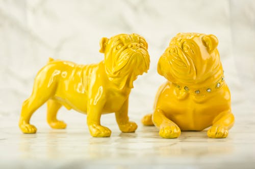 Two Yellow Bulldog Figurines