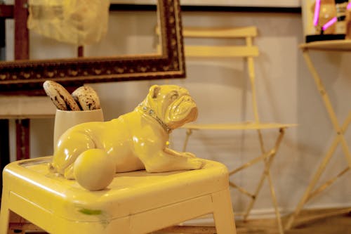 Yellow Bulldog Figurine on Yellow Chair