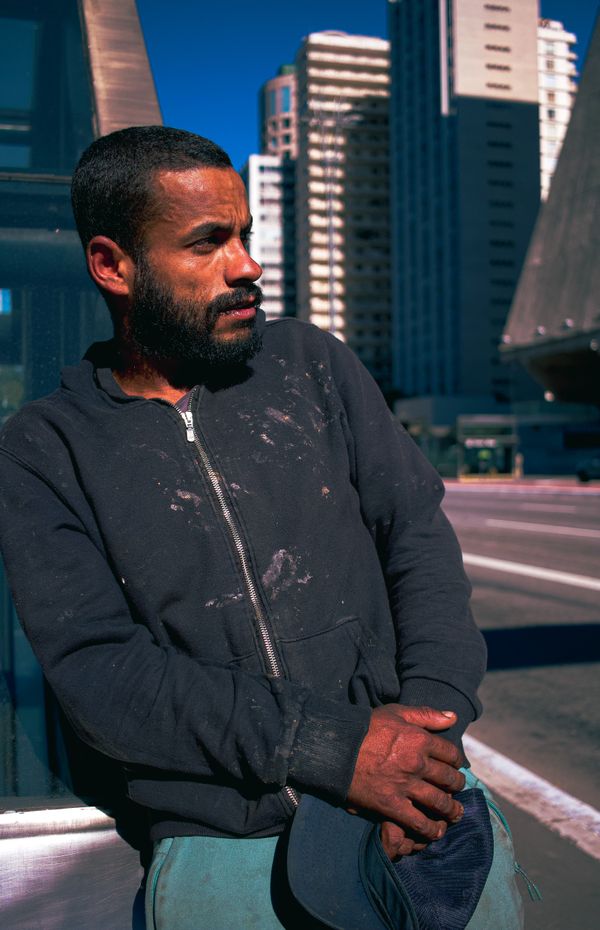 Bearded man standing on a sunlit city street — photo by Helielton S. on Pexels