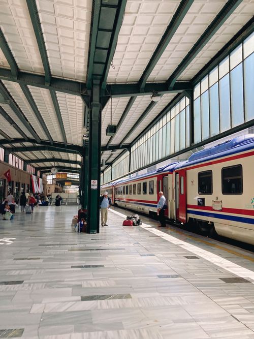 Free A vibrant scene at Ankara train station showing a modern train and passengers. Stock Photo