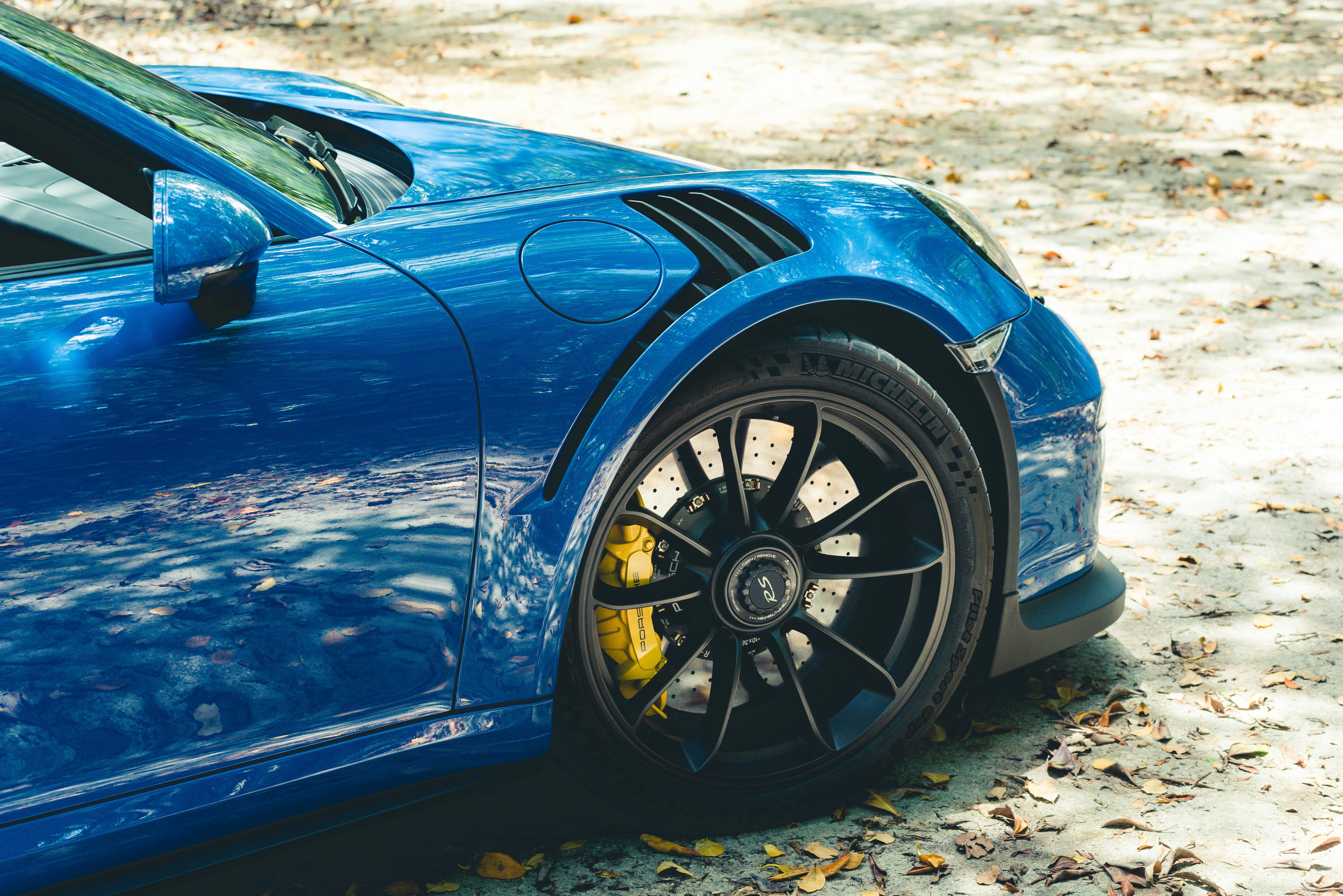 Close Up Shot of a Blue Car with Black Rims · Free Stock Photo