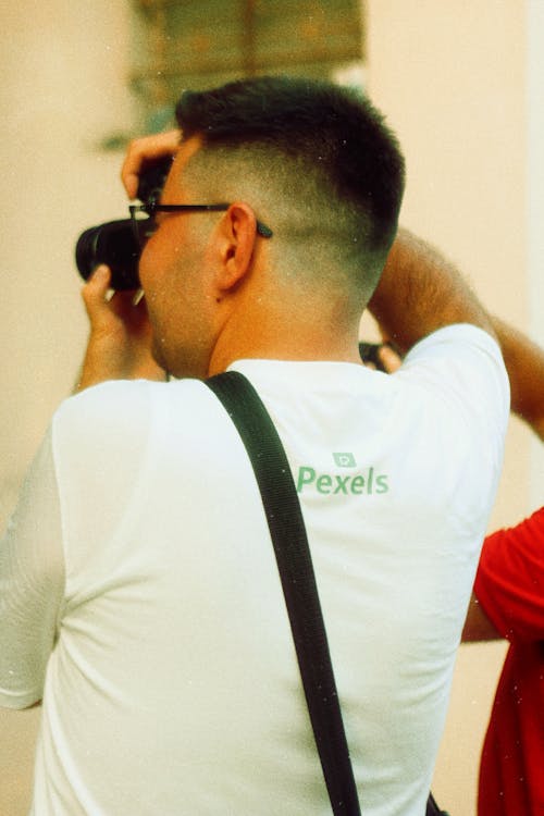 Back View of a Man Using Camera 