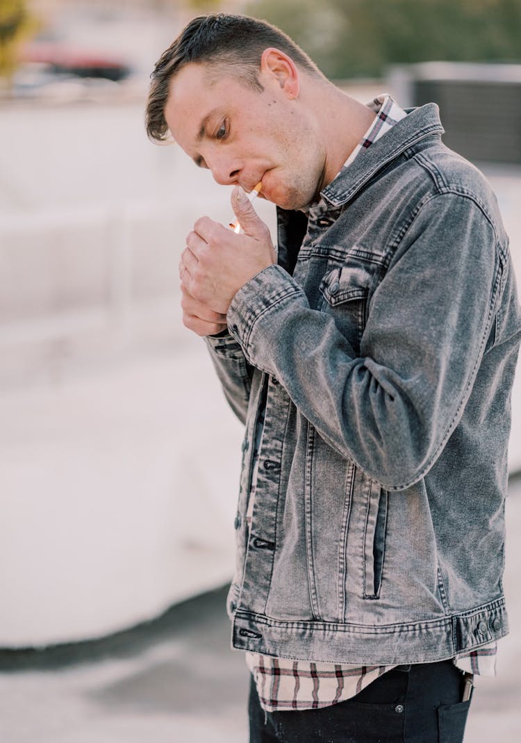 A Man Lighting A Cigarette 