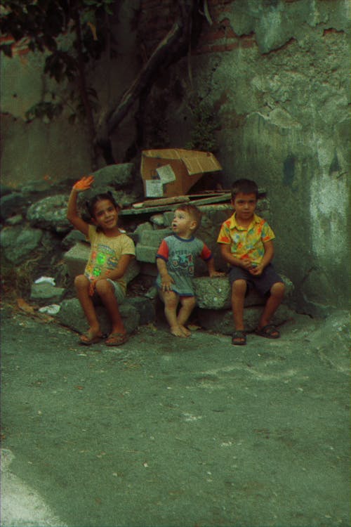 Children Sitting on Rocks