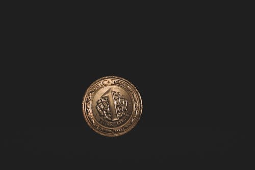 Round Gold-colored 1 Coin