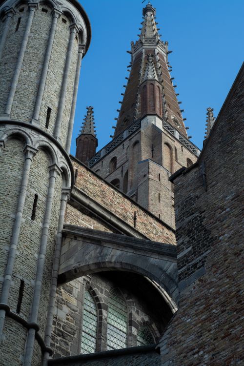 Free A stunning gothic tower with detailed architecture captured from a low angle against a clear sky. Stock Photo