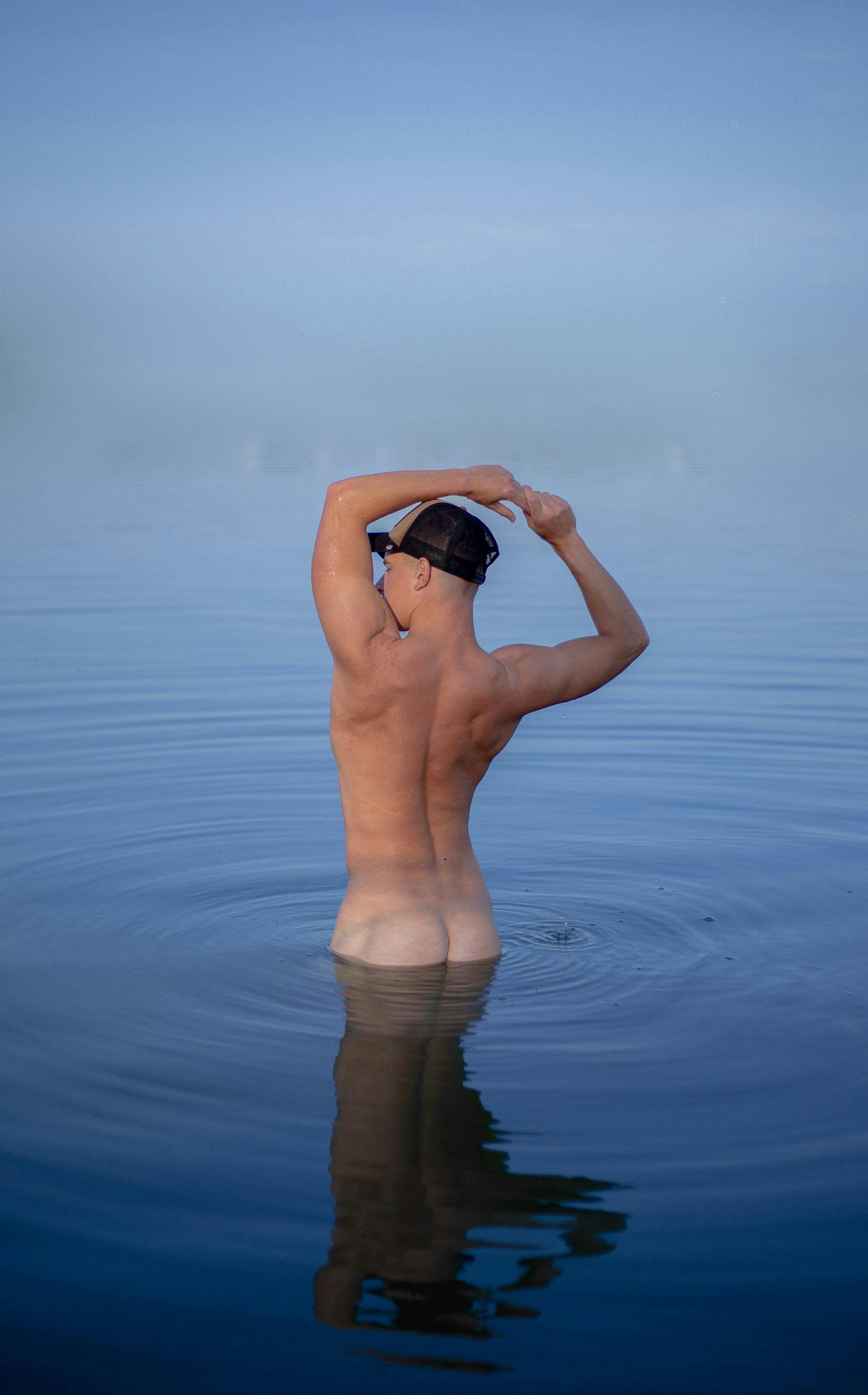 Naked Man Standing on Body of Water · Free Stock Photo