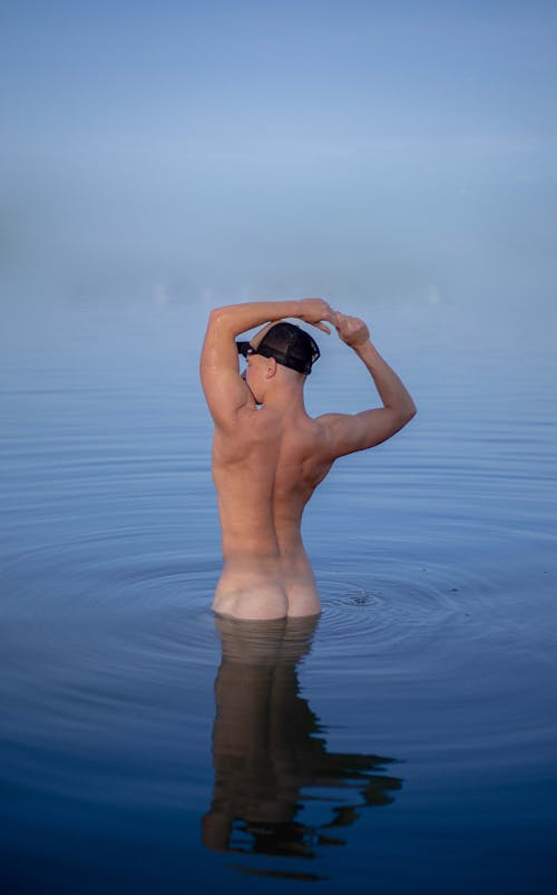 Naked Man Standing on Body of Water
