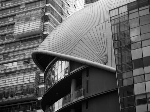 Black and White Photo of Glass Buildings and a Dome