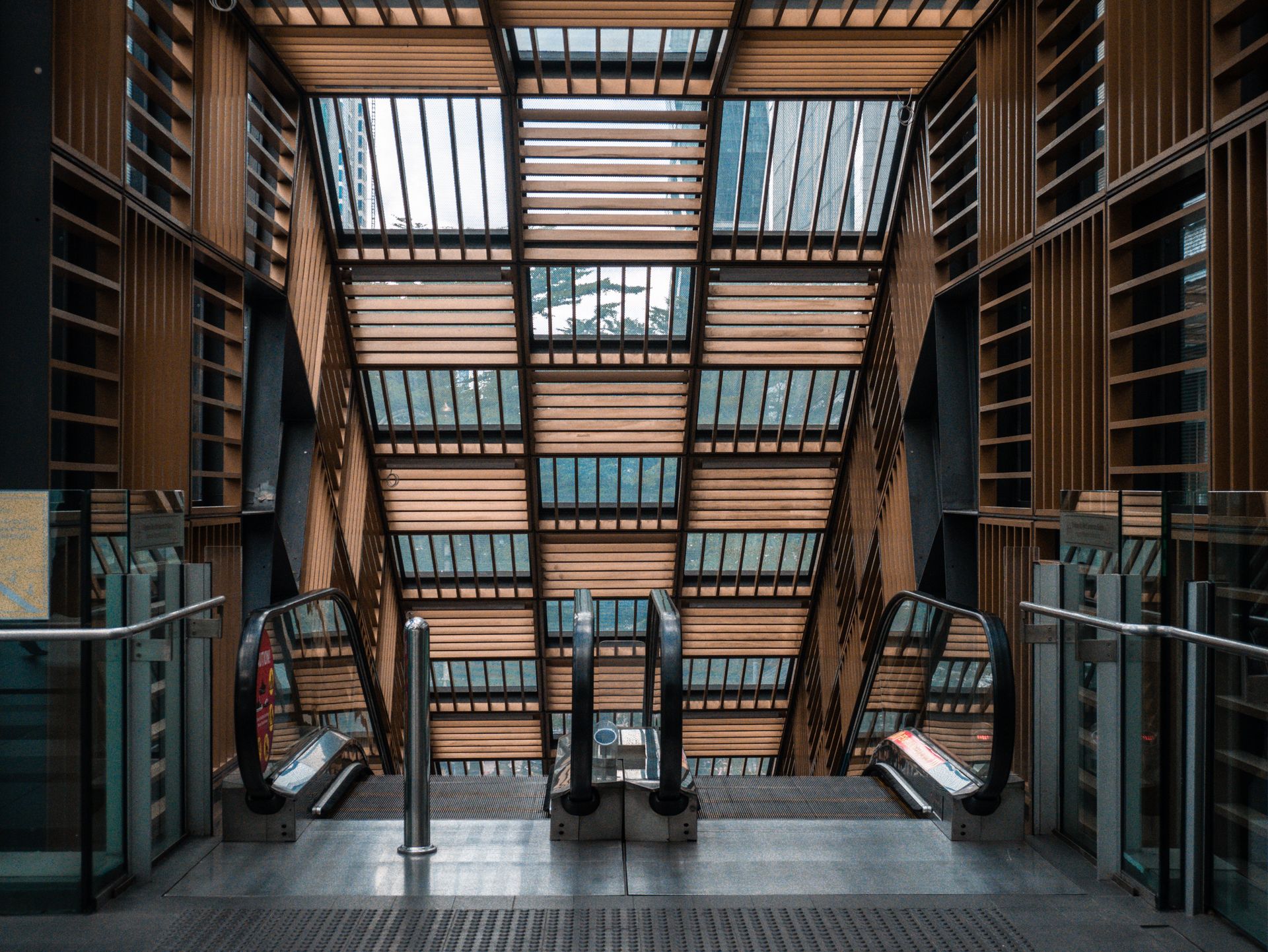 A symmetrical view of a modern escalator inside a building with unique architectural design.
