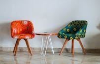 Two Assorted-color Padded Chairs Near Side Table