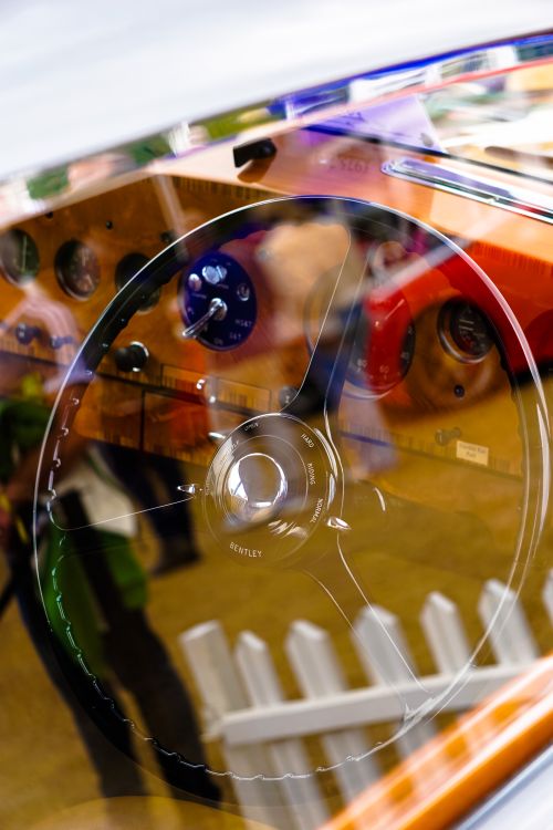 Free Close-up of a classic car interior with steering wheel and dashboard showing reflections. Stock Photo