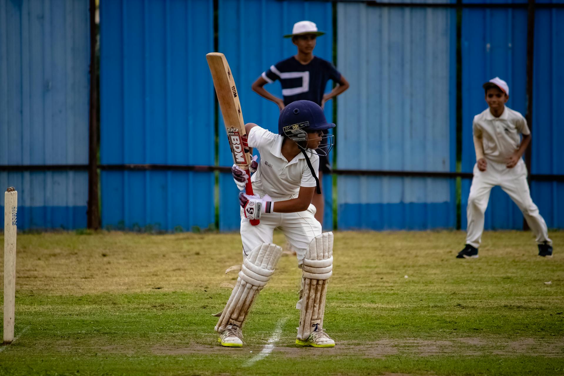 A young cricketer prepares to bat during a match in Gahunje, India.