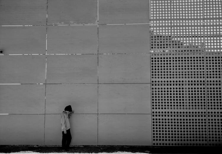 A Person Standing By A Wall