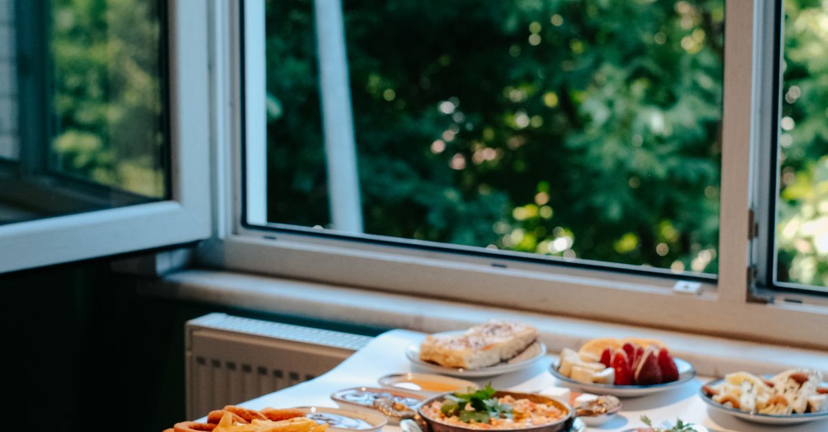 Dinner Out Window Dinner Served on a Table Next to a Window at Home · Free Stock Photo