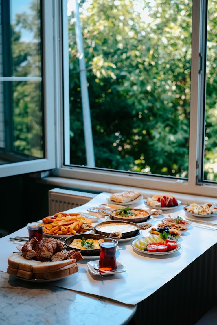 Dinner Served On A Table Next To A Window At Home 