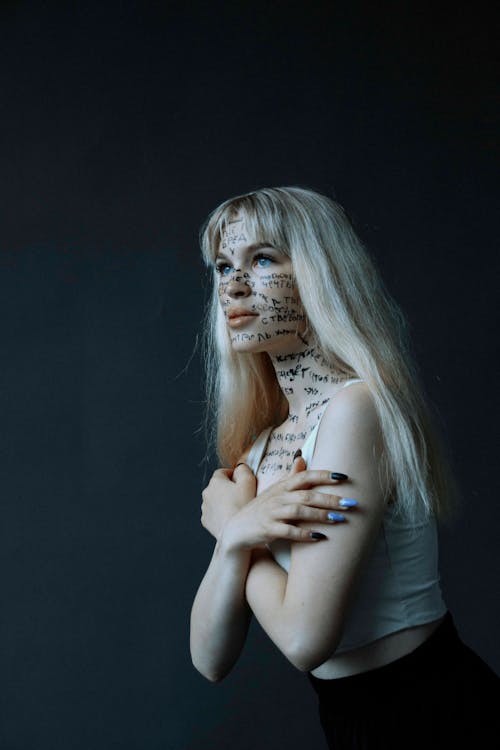 Blonde Woman Posing with Words Written All Over Her Face