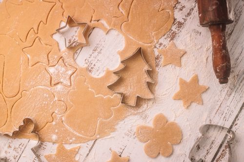 Free Top view of gingerbread cookie dough with festive shapes cut out, perfect for Christmas baking inspiration. Stock Photo