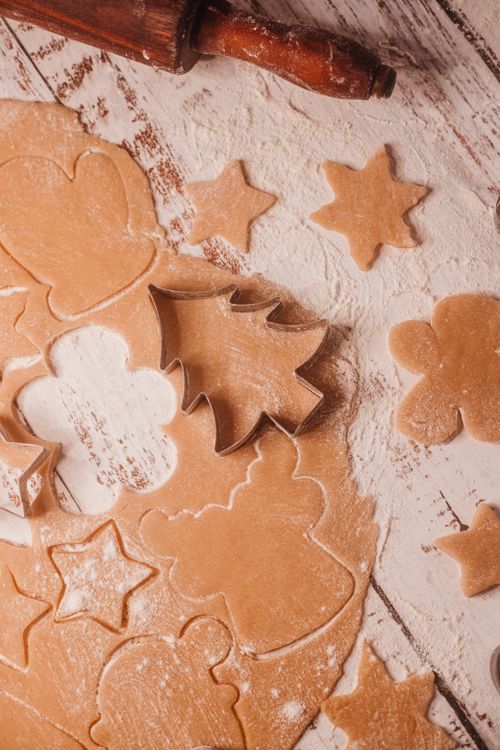 Free Top view of homemade cookie dough with various cutters and flour on a rustic wooden table. Stock Photo