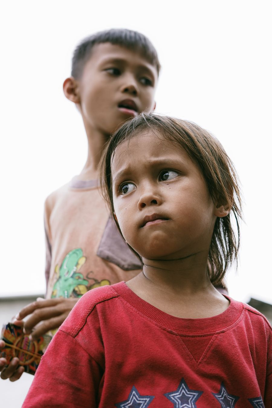 Two children standing outdoors at dusk by DEIVI RN on Pexels