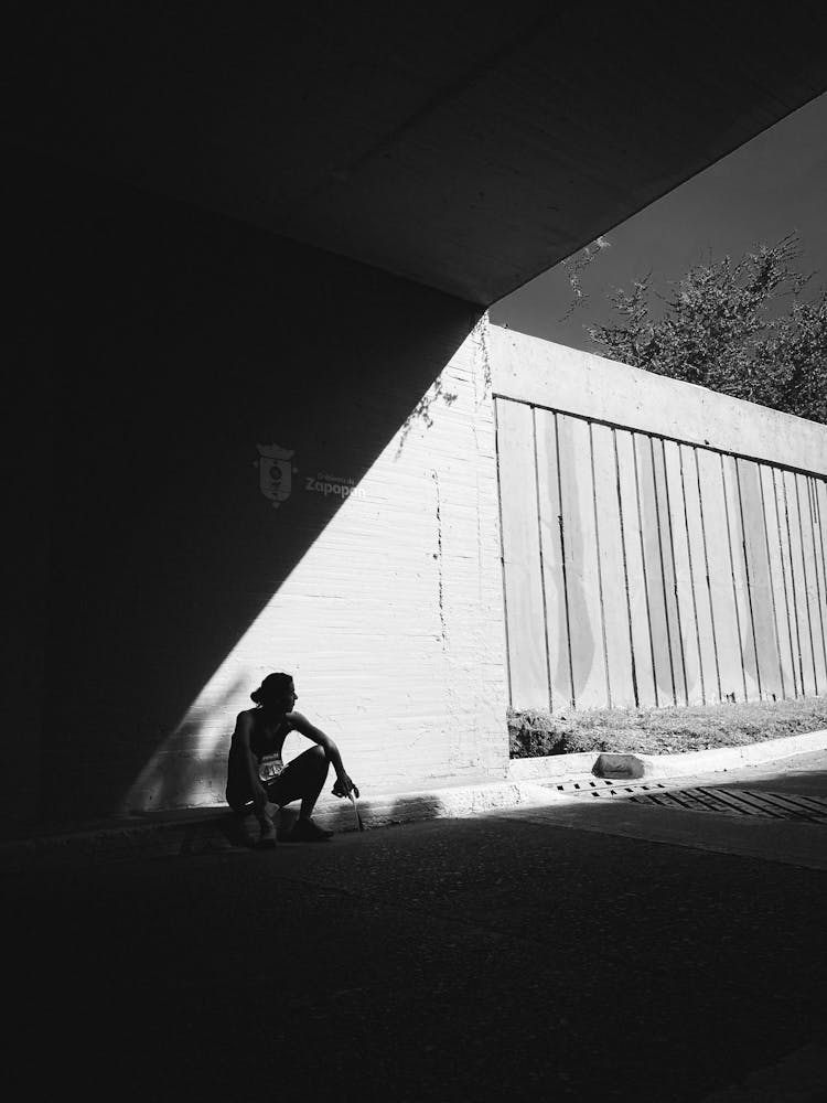 Runner Resting On Sidewalk