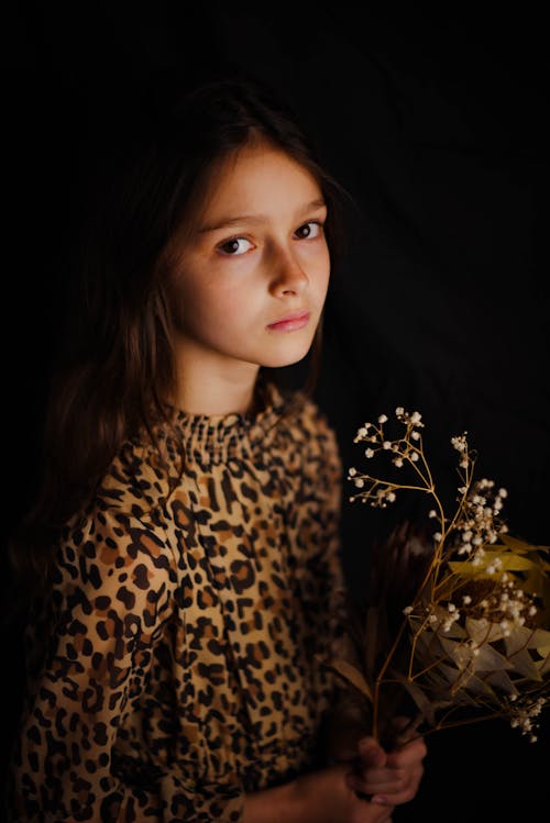 Girl Wearing Leopard Print Top Holding Flowers