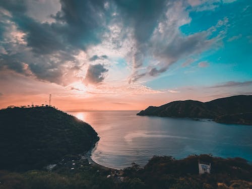 Silhouette of Mountain Near Body of Water during Sunset